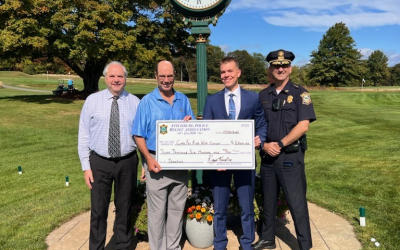 Cops for Kids with Cancer accepts a check for $3,600 from Fitchburg Police Department