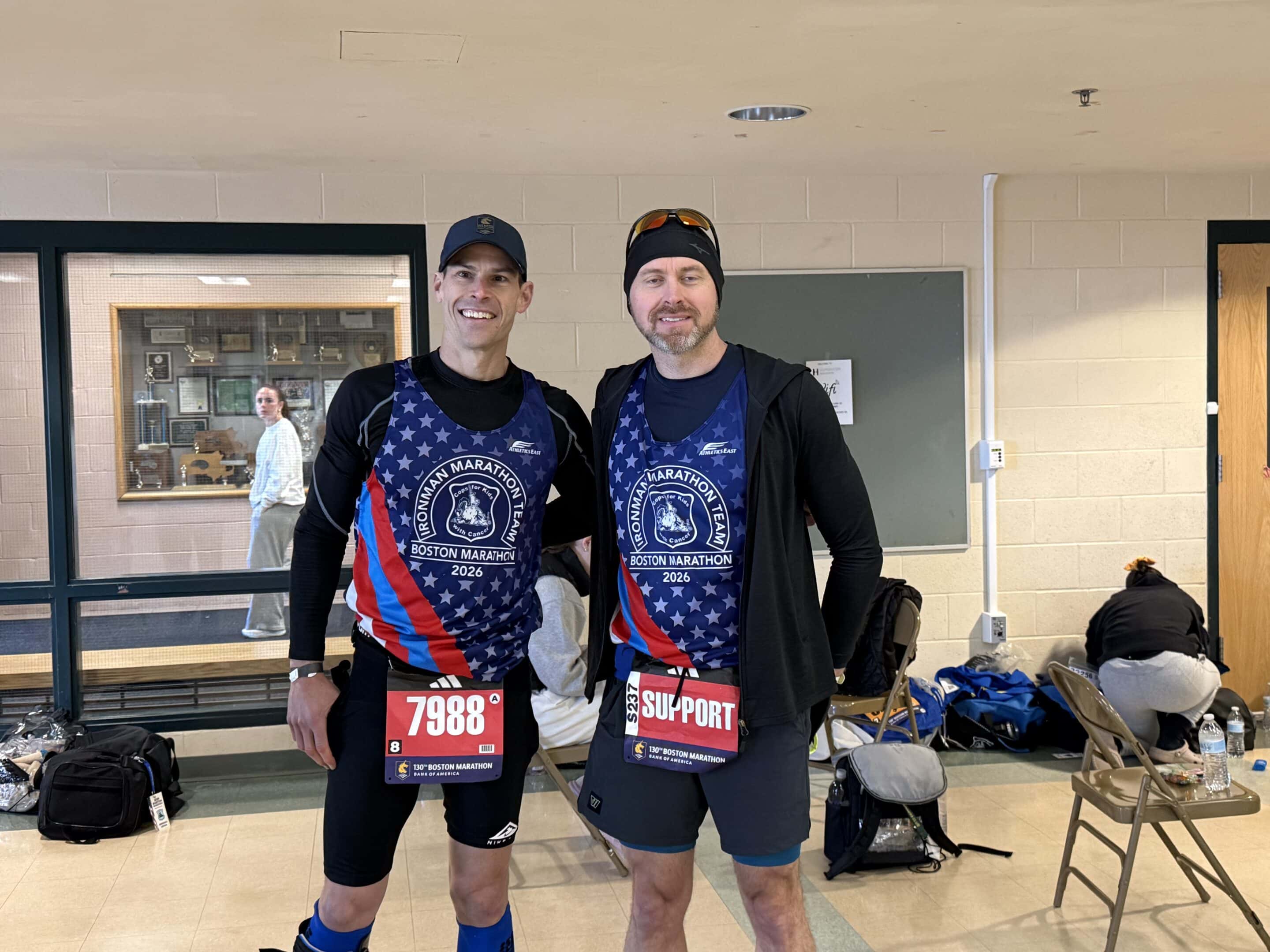Two male participants in their running tank tops.