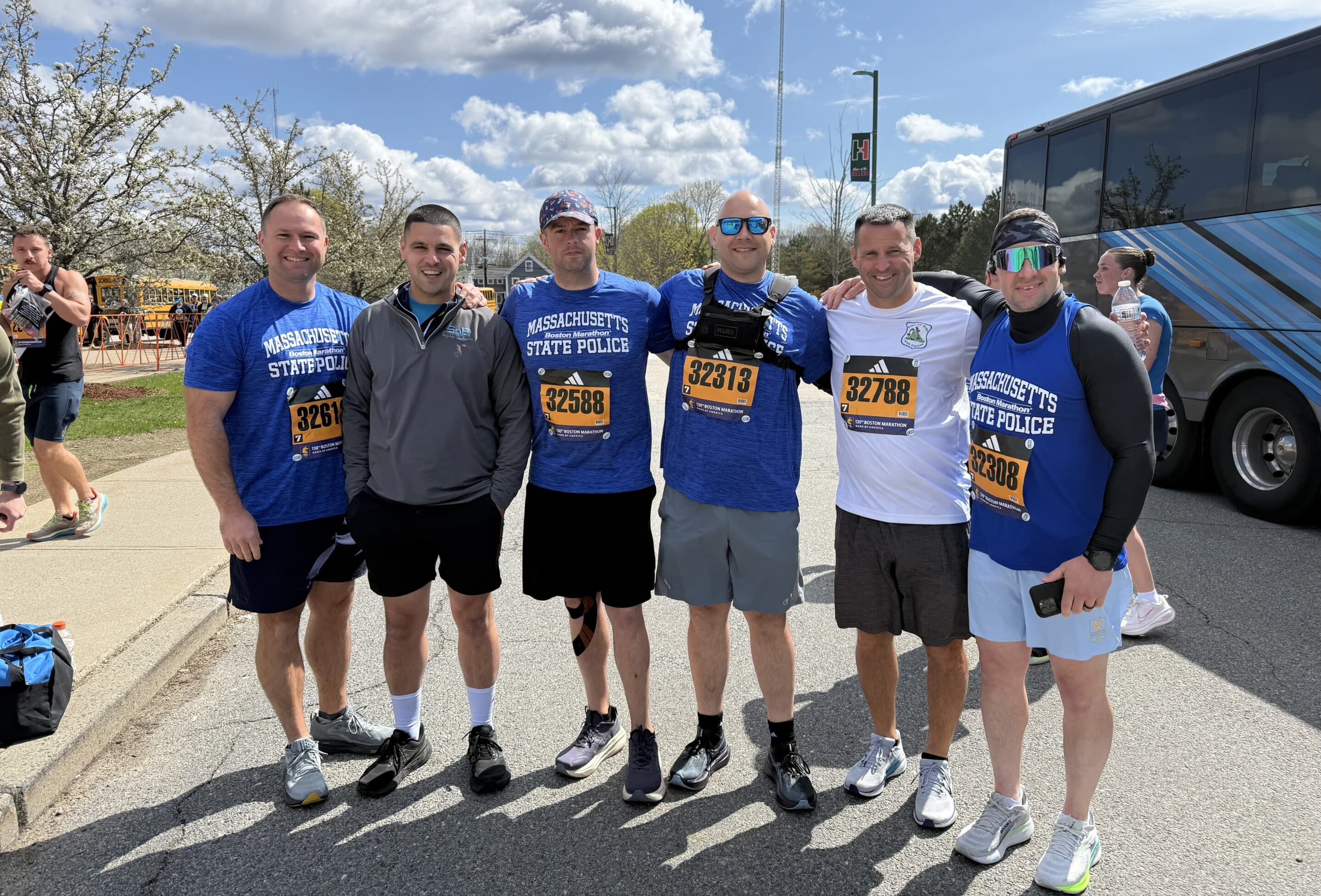 Four male participants of the 2026 Official Boston Marathon Charity Team benefiting Cops for Kids with Cancer.