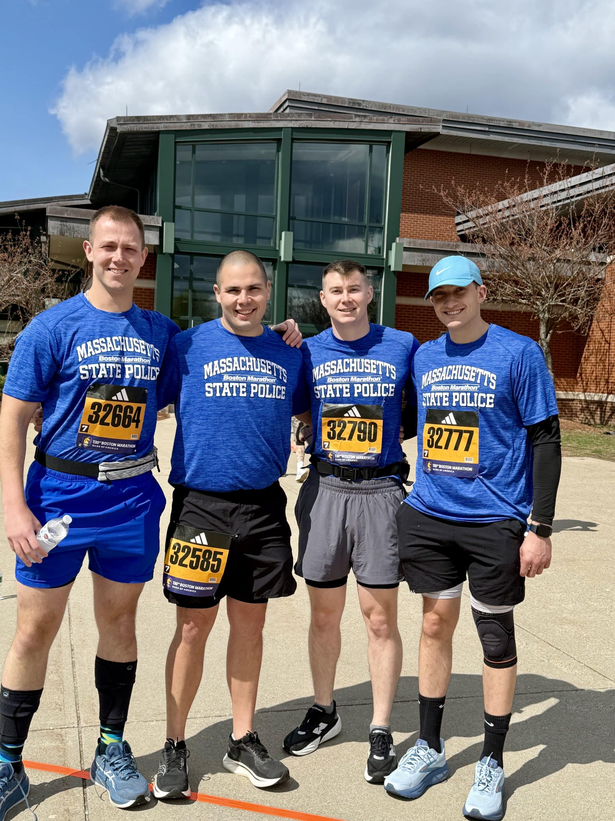 Four male participants of the 2026 Official Boston Marathon Charity Team benefiting Cops for Kids with Cancer.