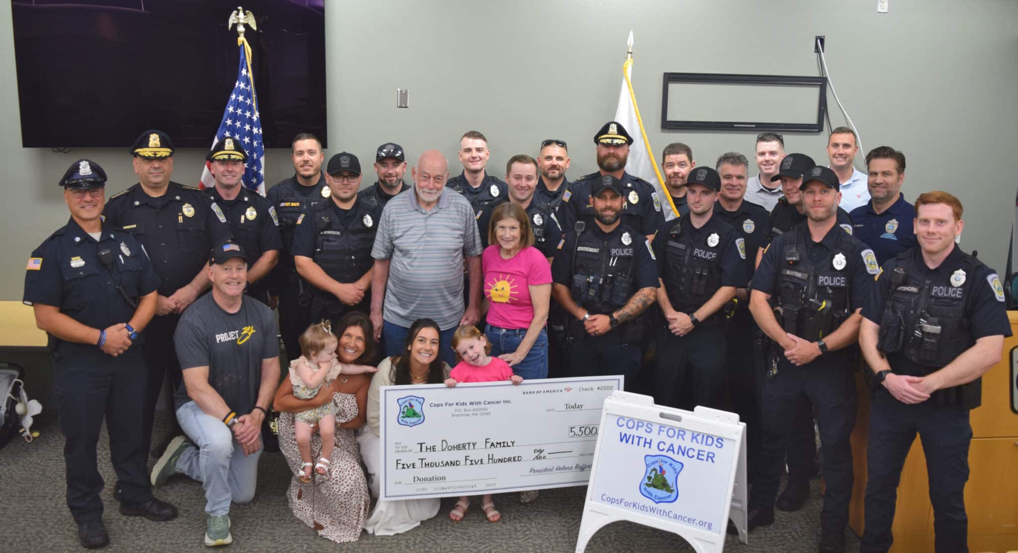 Representatives of Cops for Kids with Cancer and Chelmsford Police stand together with 5-year-old Carson Doherty and her family as the family is presented with a check for $5,500 to support their ongoing battle with Leukemia.