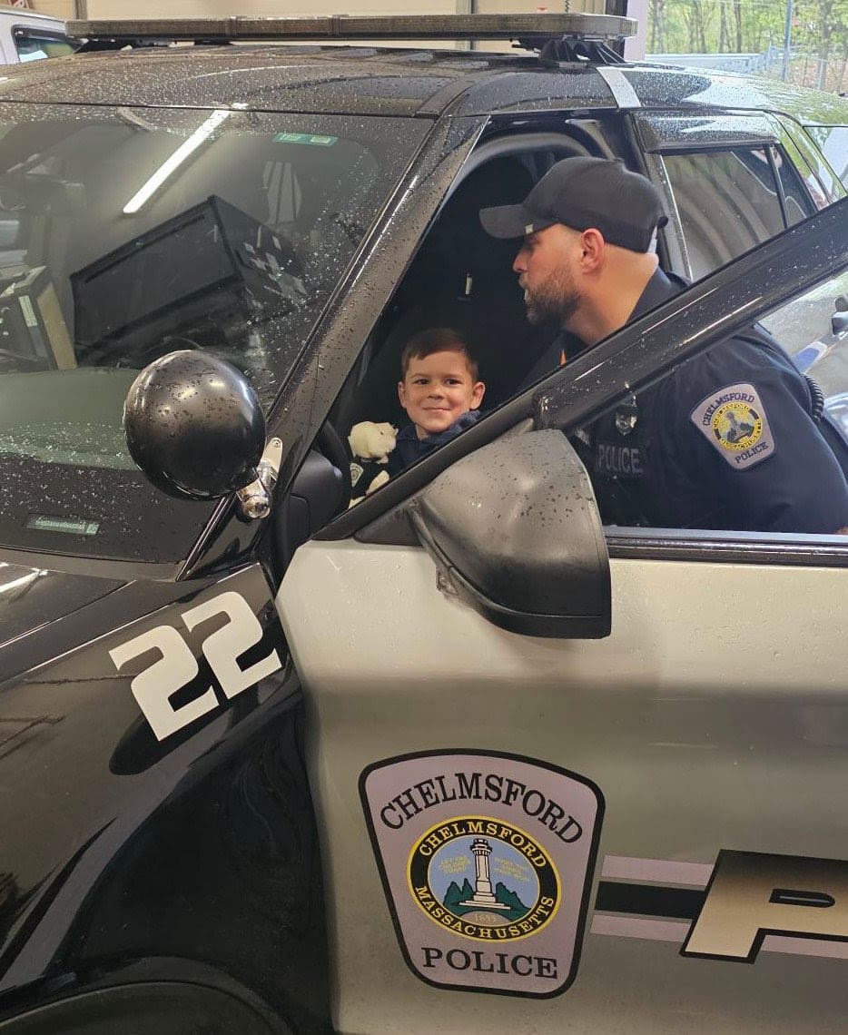 Chelmsford Police Officer Cory D'Entremont shows 6-year-old Tyler Bolger around the inside of a police cruiser during Tyler's visit to the police station with his family. Cops for Kids with Cancer and Chelmsford Police presented Tyler and his family with ,500 to help support their ongoing battle with cancer.